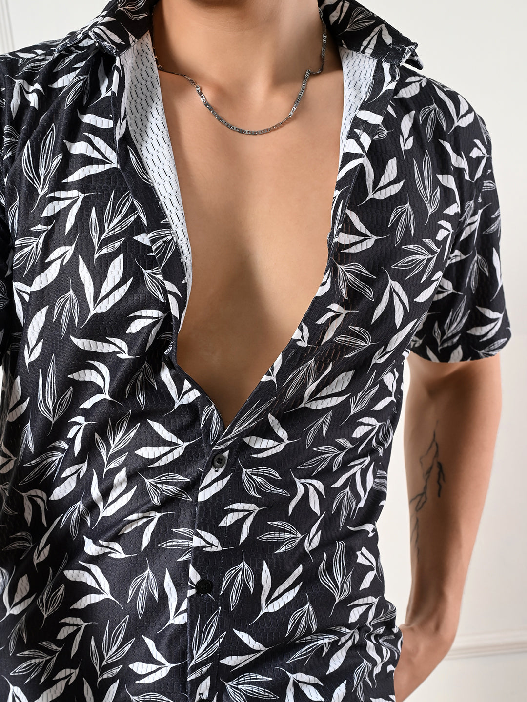 Men's black, white leaf print shirt.