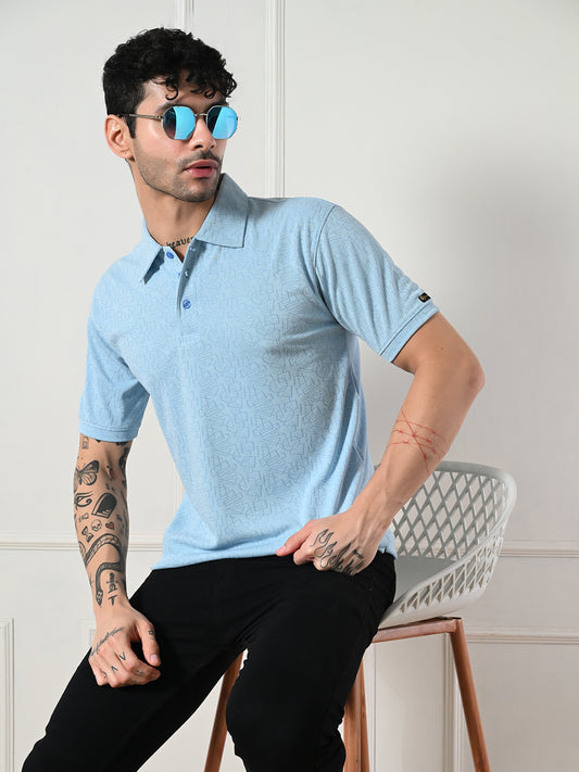 Textured light blue polo with geometric embossing.