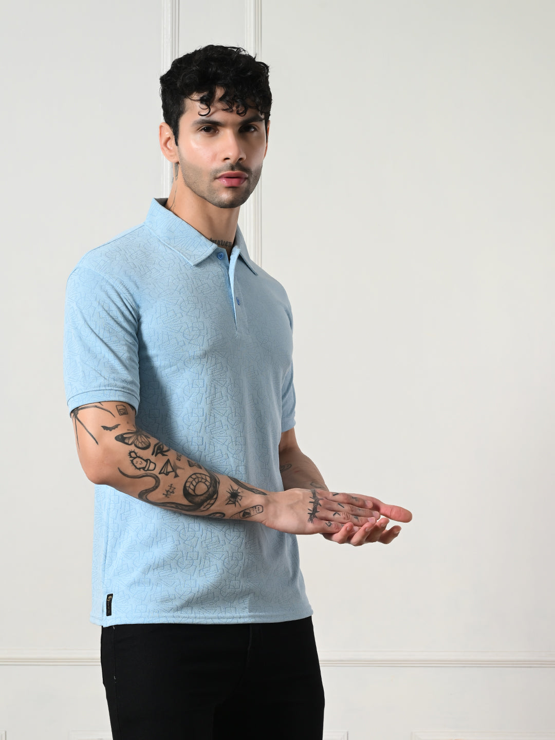Textured light blue polo with geometric embossing.