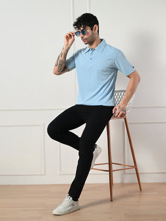 Textured light blue polo with geometric embossing.