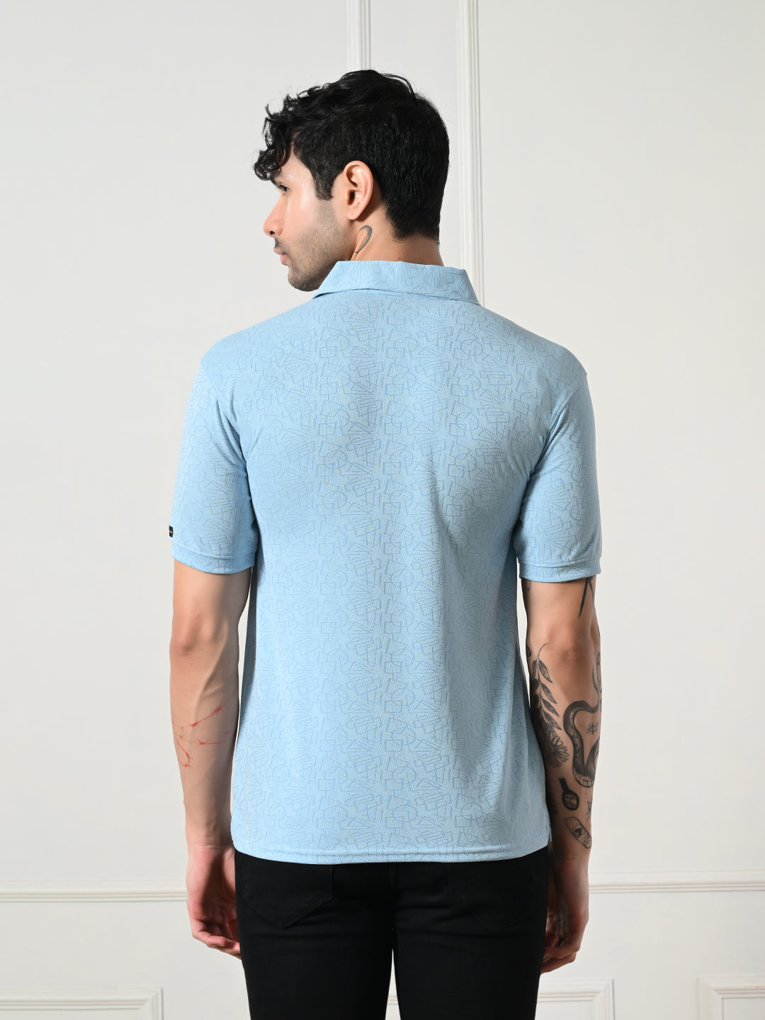 Textured light blue polo with geometric embossing.