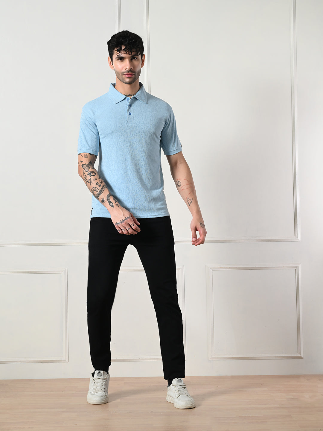 Textured light blue polo with geometric embossing.